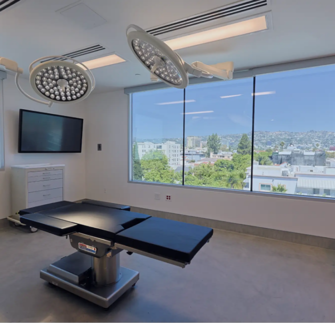 A state-of-the-art treatment room at Gramercy Center, equipped with modern lighting and a stunning city view, designed for precision and patient comfort.