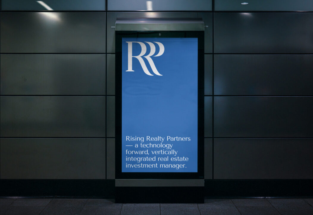 Rising Realty Partners branding displayed on a digital sign.