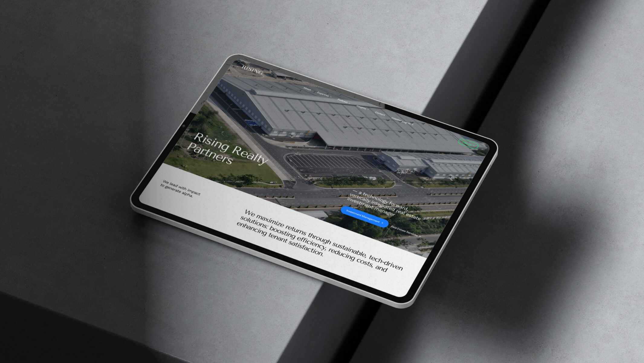 Rising Realty Partners website displayed on a tablet.