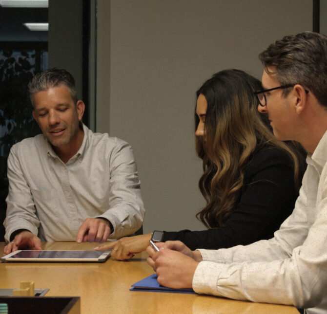 Rising Realty Partners team collaborating around a conference table.