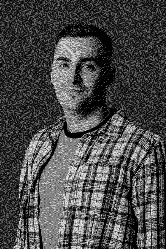 Black-and-white portrait of a man in a plaid shirt.